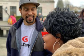 Man talking to woman with red glasses