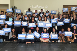 group of people holding blue and white vote signs